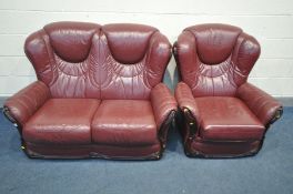 A BURGANDY LEATHER TWO PIECE LOUNGE SUITE, comprising a two seater sofa and an armchair (