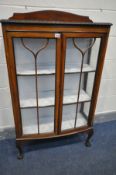 AN EARLY 20TH CENTURY WALNUT TWO DOOR DISPLAY CABINET, enclosing two fixed shelves, on cabriole legs