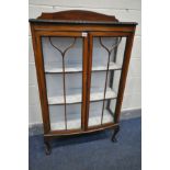 AN EARLY 20TH CENTURY WALNUT TWO DOOR DISPLAY CABINET, enclosing two fixed shelves, on cabriole legs