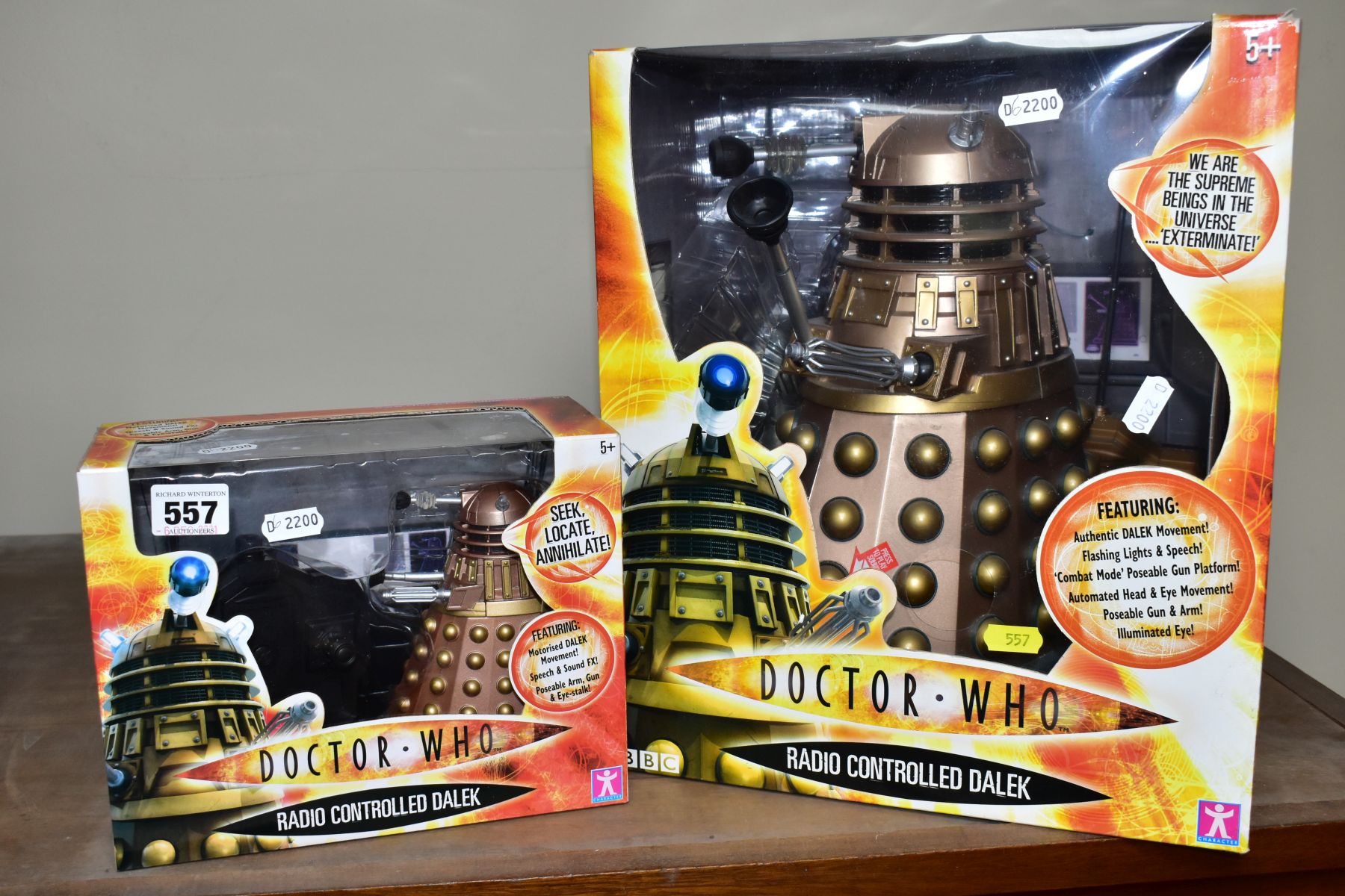 TWO BOXED RADIO CONTROLLED DALEKS, comprising a Character Options Ltd copper coloured radio