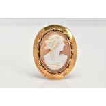 A YELLOW METAL CAMEO BROOCH, of an oval form, depicting a lady in profile, collet mount with a