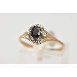 A 9CT GOLD SAPPHIRE RING, designed with a claw set, oval cut blue sapphire, within a textured