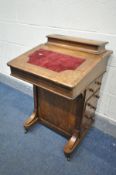 A LATE VICTORIAN WALNUT DAVENPORT, with a red baize inlay, four drawers and dummy drawers