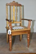 A WOODEN DOLLS CHAIR, with woven leather thong seat, made from varied timbers, label underneath