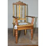 A WOODEN DOLLS CHAIR, with woven leather thong seat, made from varied timbers, label underneath