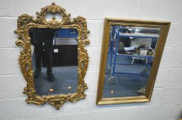 A LATE 20TH CENTURY GILT FRAMED ROCOCO WALL MIRROR, with scrolling acanthus leaves, 56cm x 94cm, and