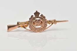 A YELLOW METAL MILITARY BROOCH, in the form of a rifle and the Royal Engineers emblem, fitted with a