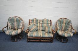 A WICKER CONSERVATORY SUITE, comprising a two seater sofa and a pair of egg swivel/reclining