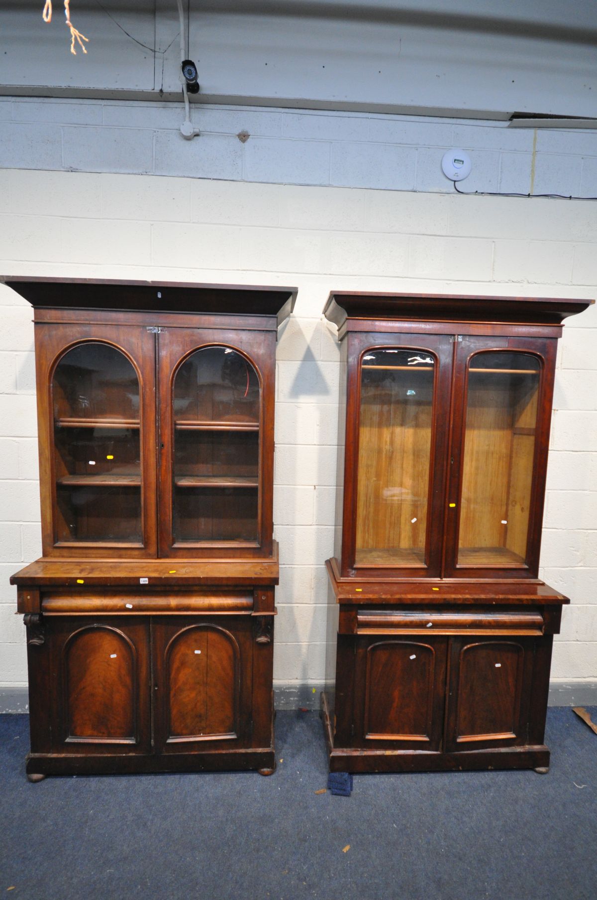 TWO VICTORIAN MAHOGANY BOOKCASES, with double glazed doors above a frieze drawer and cupboard doors,