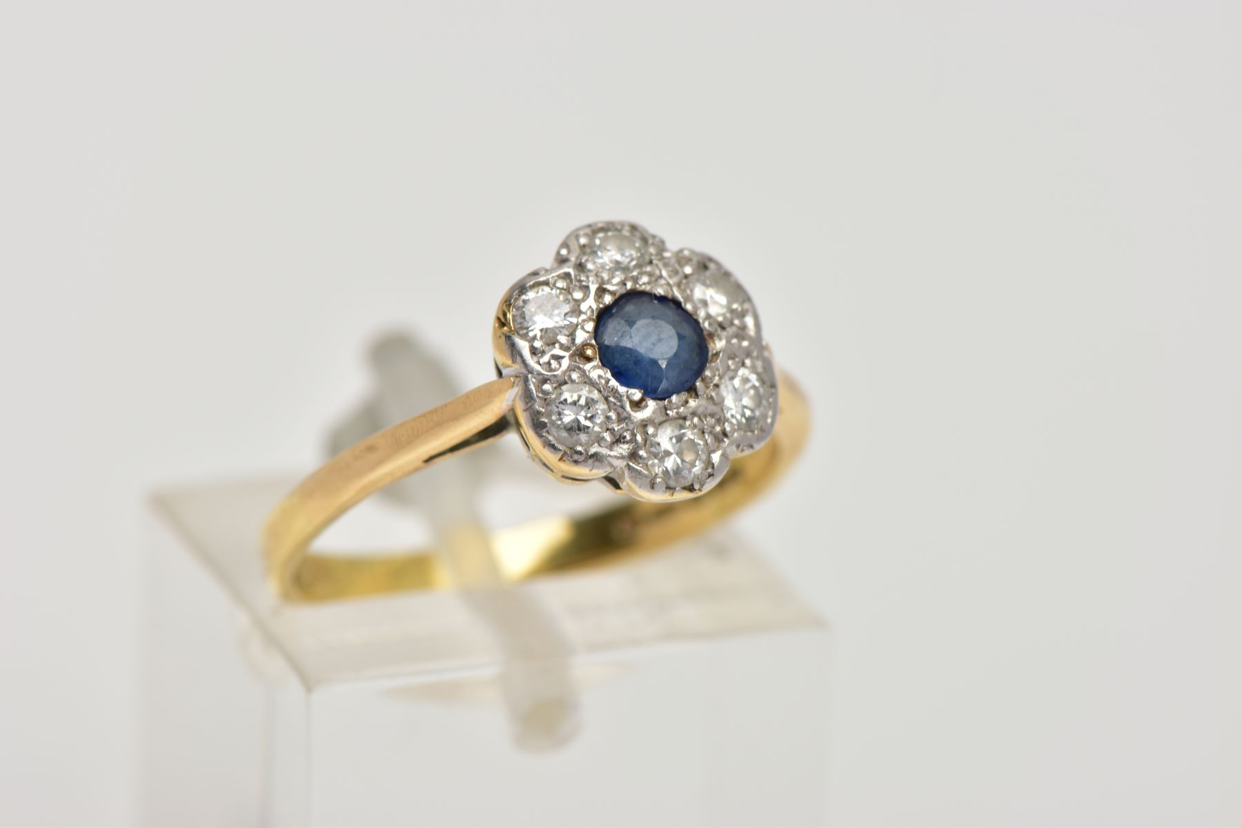 AN 18CT GOLD SAPPHIRE AND DIAMOND CLUSTER RING, of a flower shape, centring on a circular cut blue - Image 4 of 4