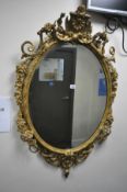 A GILTWOOD LOUIS XVI FRENCH STYLE WALL MIRROR, having a later bevelled plate, the frame with