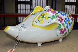 A LARGE ARTHUR WOOD PIGGY BANK, in the form of a whimsical pig with pink, blue and yellow floral