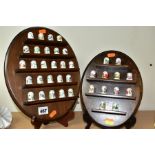 TWO WALL HANGING THIMBLE DISPLAY SHELVES CONTAINING MODERN PORCELAIN THIMBLES, comprising a set of