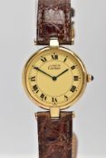 A SILVER GILT 'CARTIER' QUARTZ WRISTWATCH, round cream dial signed 'Must De Cartier', Roman