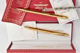 A CASED 'CARTIER' BALL POINT PEN AND A CASED PROPELLING PENCIL, to include a 'Must De Cartier,