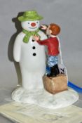 A ROYAL DOULTON LIMITED EDITION 'THE SNOWMAN AND JAMES 'DRESSING THE SNOWMAN', no.677 of 2500,