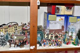 A THIRTY PIECE CERAMIC AND RESIN CHRISTMAS VILLAGE, items from different manufacturers to include