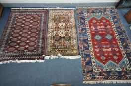 A TURKISH DOSEMEALTI RUG, with deep blue, red and central lozenge medallions, 240cm x 150cm, a