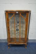 AN EARLY 20TH CENTURY WALNUT CHINA CABINET, a single glazed door enclosing two glass shelves, on