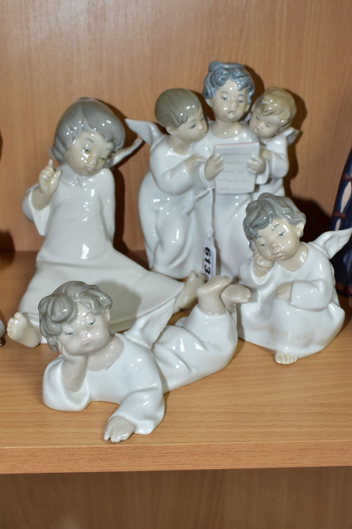 FOUR LLADRO ANGEL FIGURINES COMPRISING 'ANGELS' THREE ANGELS SINGING FROM A SHEEET OF MUSIC 1004542,