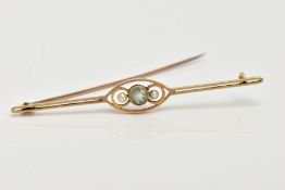 A YELLOW METAL BAR BROOCH, centring on a circular cut aquamarine, flanked with seed pearls, within
