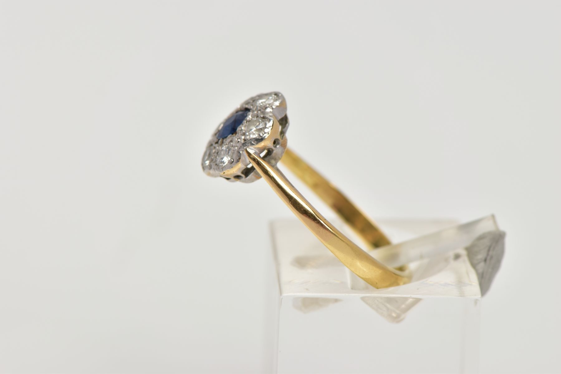 AN 18CT GOLD SAPPHIRE AND DIAMOND CLUSTER RING, of a flower shape, centring on a circular cut blue - Image 2 of 4