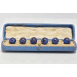 A CASED SET OF GLASS DRESS STUDS, comprising of six blue with red swirl glass ball studs, each