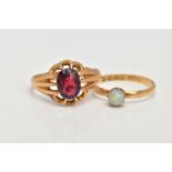 TWO 18CT GOLD RINGS, the first designed with a ten claw set, oval cut garnet (damaged), scallop