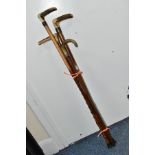 FOUR WALKING STICKS, various materials, one malacca stick, three have antler handles, one with a