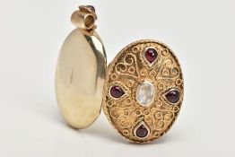 A SILVER GILT LOCKET PENDANT, of an oval form, set with a central oval cut moonstone, with red