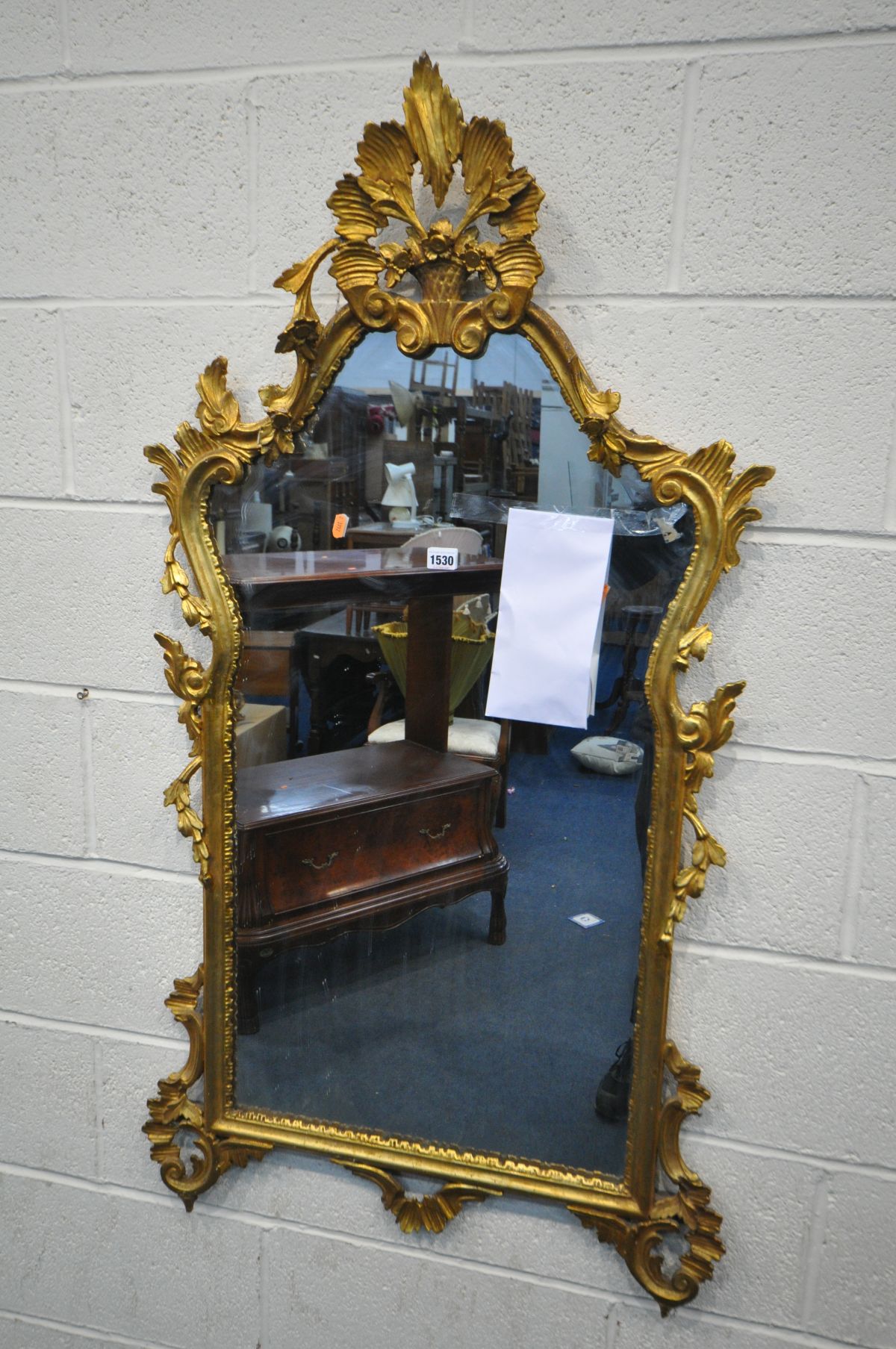 A FRENCH STYLE GILTWOOD WALL MIRROR, with acanthus leaves, flower heads below a still life surmount,