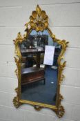 A FRENCH STYLE GILTWOOD WALL MIRROR, with acanthus leaves, flower heads below a still life surmount,