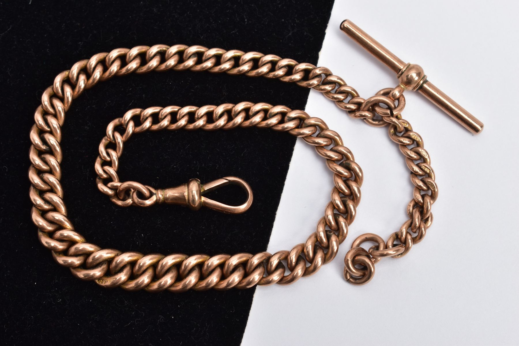 A 9CT ROSE GOLD ALBERT CHAIN, graduated curb link chain, fitted with a T-bar stamped '9.375', each