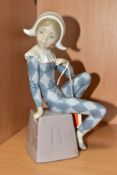 A LLADRO FIGURINE HARLEQUIN B, NO.5076, depicting a harlequin boy seated on a block impressed with