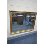 A LARGE GILT FRAMED BEVELLED EDGE WALL MIRROR, 139cm x 106cm (condition:-paint splatters to frame)