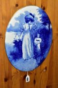 A DOULTON BURSLEM OVAL BLUE AND WHITE PLAQUE, decorated with a scene of a mother and child, gilt