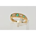 A YELLOW METAL EMERALD AND DIAMOND HALF ETERNITY RING, designed with a row of three cushion cut