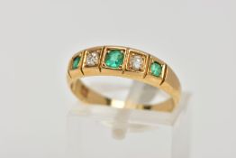 A YELLOW METAL EMERALD AND DIAMOND HALF ETERNITY RING, designed with a row of three cushion cut