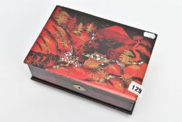AN ORIENTAL MUSICAL JEWELLERY BOX, black and red oriental design inlayed with abalone shell, opens