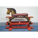 A VINTAGE TRESTLE ROCKING HORSE with a red leatherette seat
