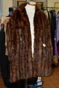 A LADIES DARK BROWN FUR COAT, with hook fastenings at waist and collar, approximate size 14-16,