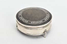 A SILVER AND TORTOISESHELL BOX, of a circular form, plain polished body raised on three scroll feet,