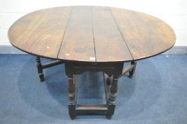 A GEORGIAN OAK GATE LEG TABLE, the oval top on turned and blocks legs, with a single drawer, open