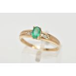 AN EMERALD RING, oval cut emerald measuring approximately 6mm x 4mm, prong set, also featuring