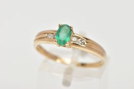 AN EMERALD RING, oval cut emerald measuring approximately 6mm x 4mm, prong set, also featuring