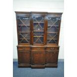 A REPRODUCTION MAHOGANY TRIPLE DOOR BREAKFRONT BOOKCASE, over three drawer and three cupboard doors,