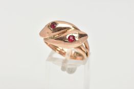 A 9CT GOLD SNAKE HEAD RING, double snake heads, set with two circular cut red paste stones in a star