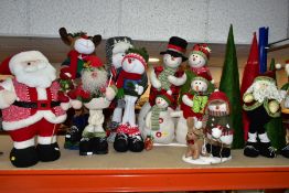 TWELVE LARGE FABRIC CHRISTMAS FIGURE DECORATIONS, freestanding, comprising eight snowmen: one family