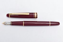 A MONTBLANC FOUNTAIN PEN, burgundy lacquer with gold detailing, signed 'Montblanc-Meisterstuck'