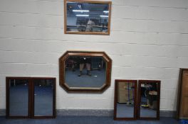A RECTANGULAR WALNUT ART DECO STYLE WALL MIRROR with canted corners and bevel edge glass, 102cm x